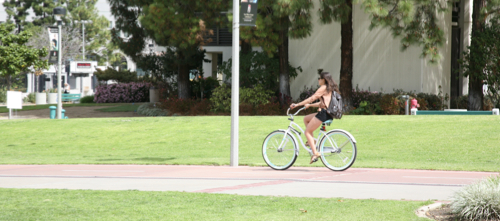 girl on bicycle riding on campus
