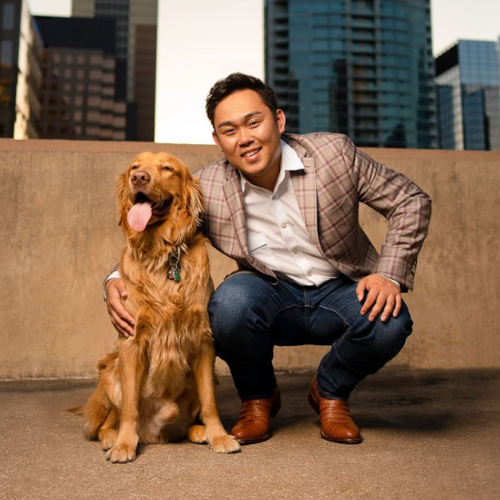 Photo of Michael Kumura with a golden retriever