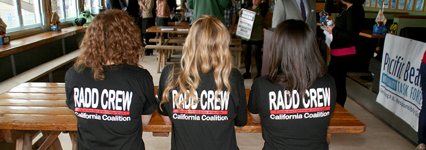 RADD crewin their matching black RADD crew california coaltions t-shirts, sitting at table in restaurant